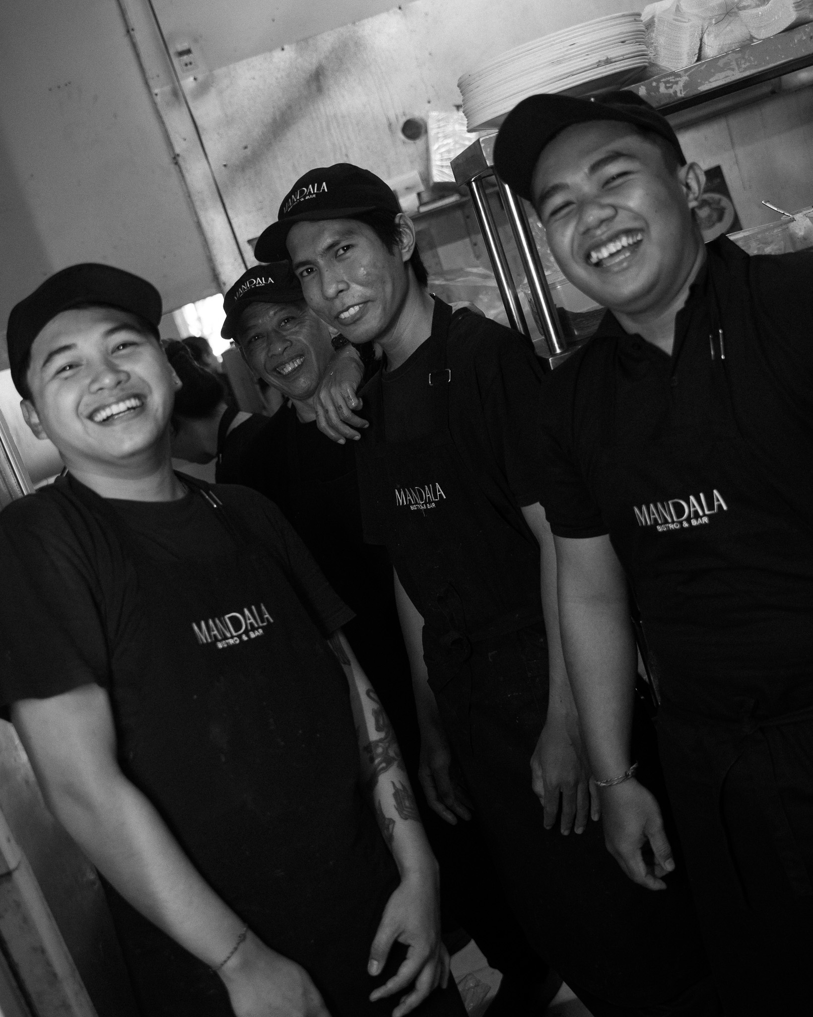 Mandala Bar staff smiling and posing together, creating a friendly and welcoming atmosphere.